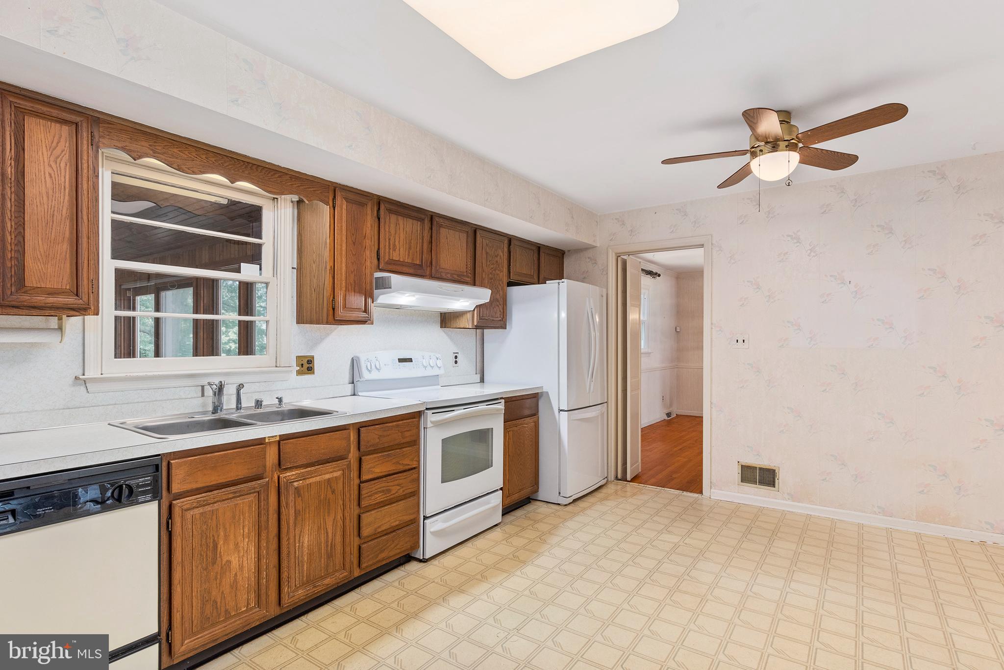 316 Caravel Drive Bear, DE 19701 - Photo 10 of 47 a kitchen with stainless steel appliances granite countertop a sink and cabinets with wooden floor