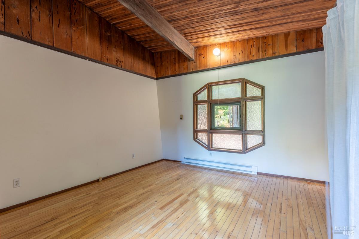 32371 Middle Ridge Road Albion, CA 95410 - Photo 12 of 35 an empty room with wooden floor and windows