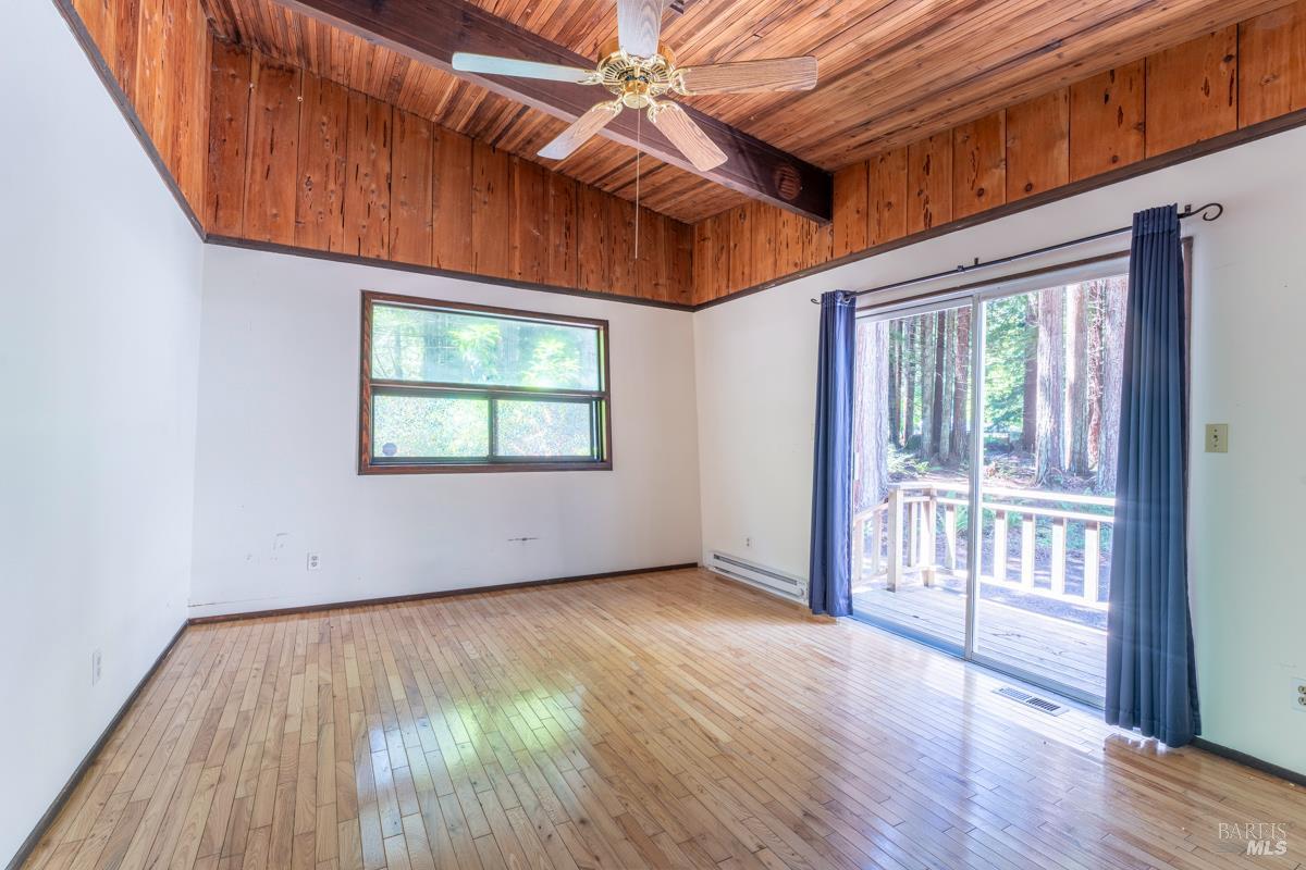 32371 Middle Ridge Road Albion, CA 95410 - Photo 18 of 35 an empty room with wooden floor and windows