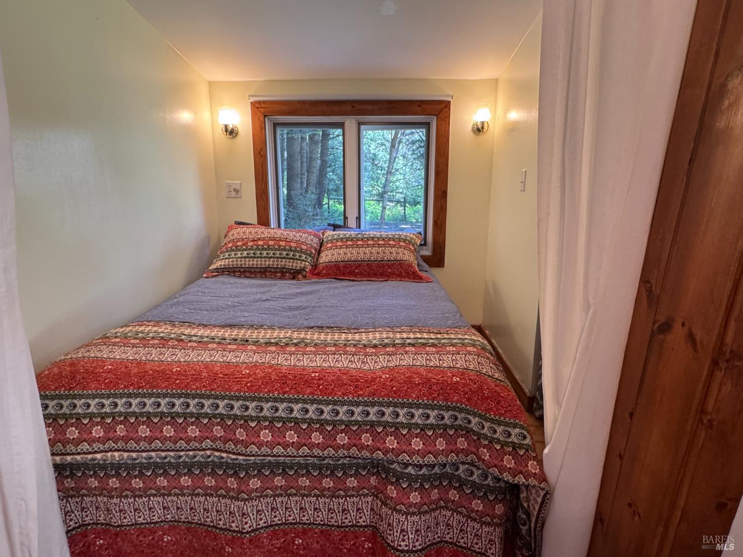 32371 Middle Ridge Road Albion, CA 95410 - Photo 30 of 35 a bedroom with a bed and a window