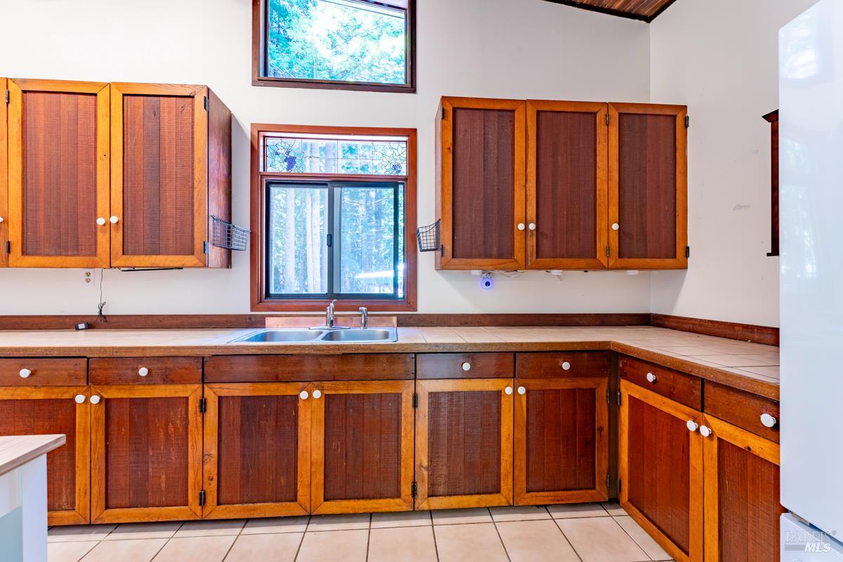 32371 Middle Ridge Road Albion, CA 95410 - Photo 9 of 35 a kitchen with wooden cabinets and a sink
