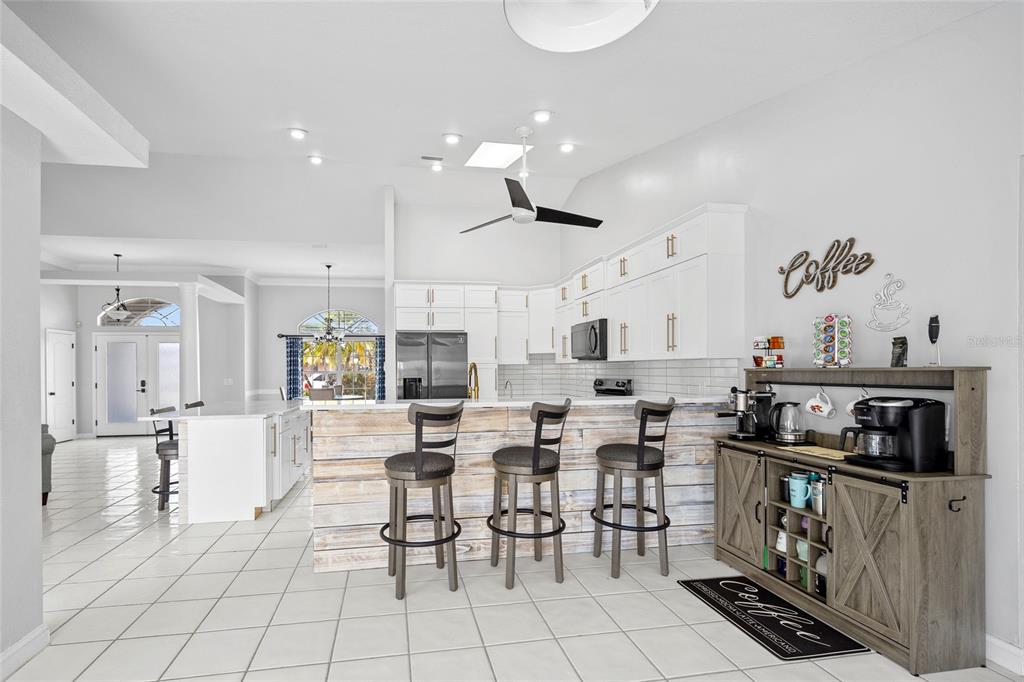 474 Orlando Boulevard Port Charlotte, FL 33954 - Photo 13 of 36 a very nice looking open dining room with kitchen island stainless steel appliances a table and chair
