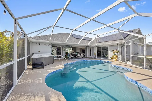 a view of a patio with a table and chairs under an umbrella