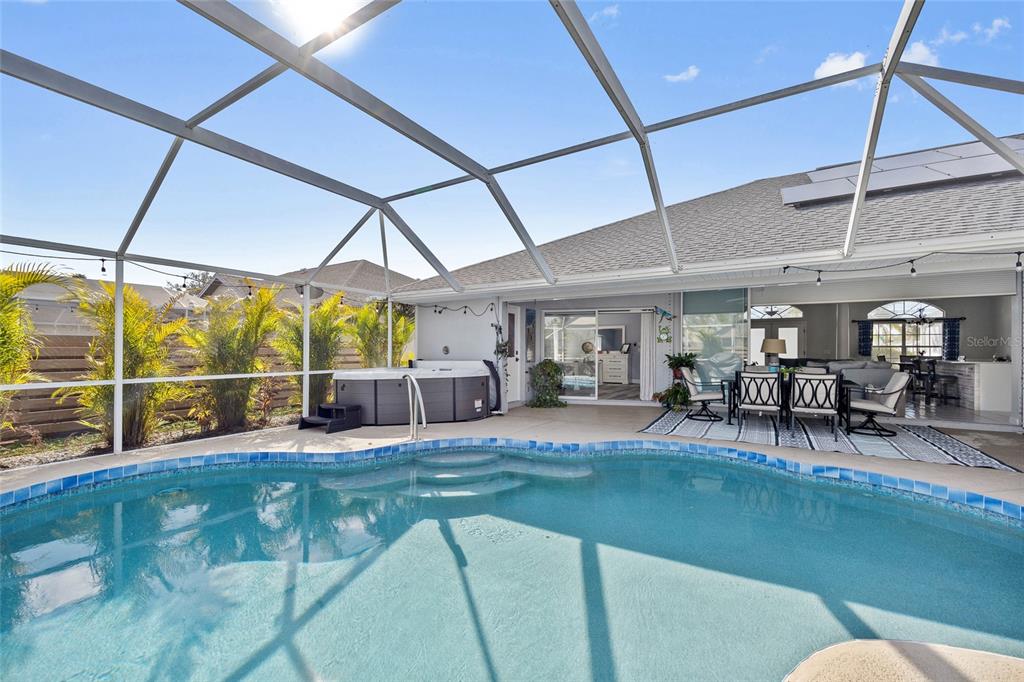 474 Orlando Boulevard Port Charlotte, FL 33954 - Photo 28 of 36 a view of a backyard with table and chairs under an umbrella