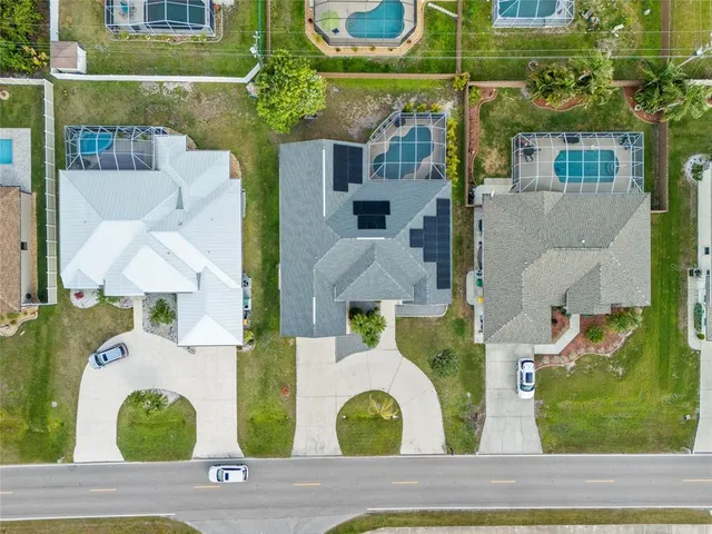an aerial view of a house with a swimming pool