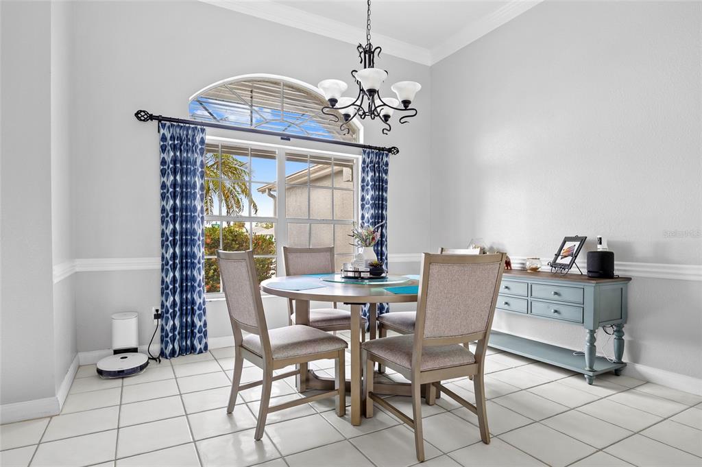 474 Orlando Boulevard Port Charlotte, FL 33954 - Photo 5 of 36 a dining room with furniture a chandelier and window