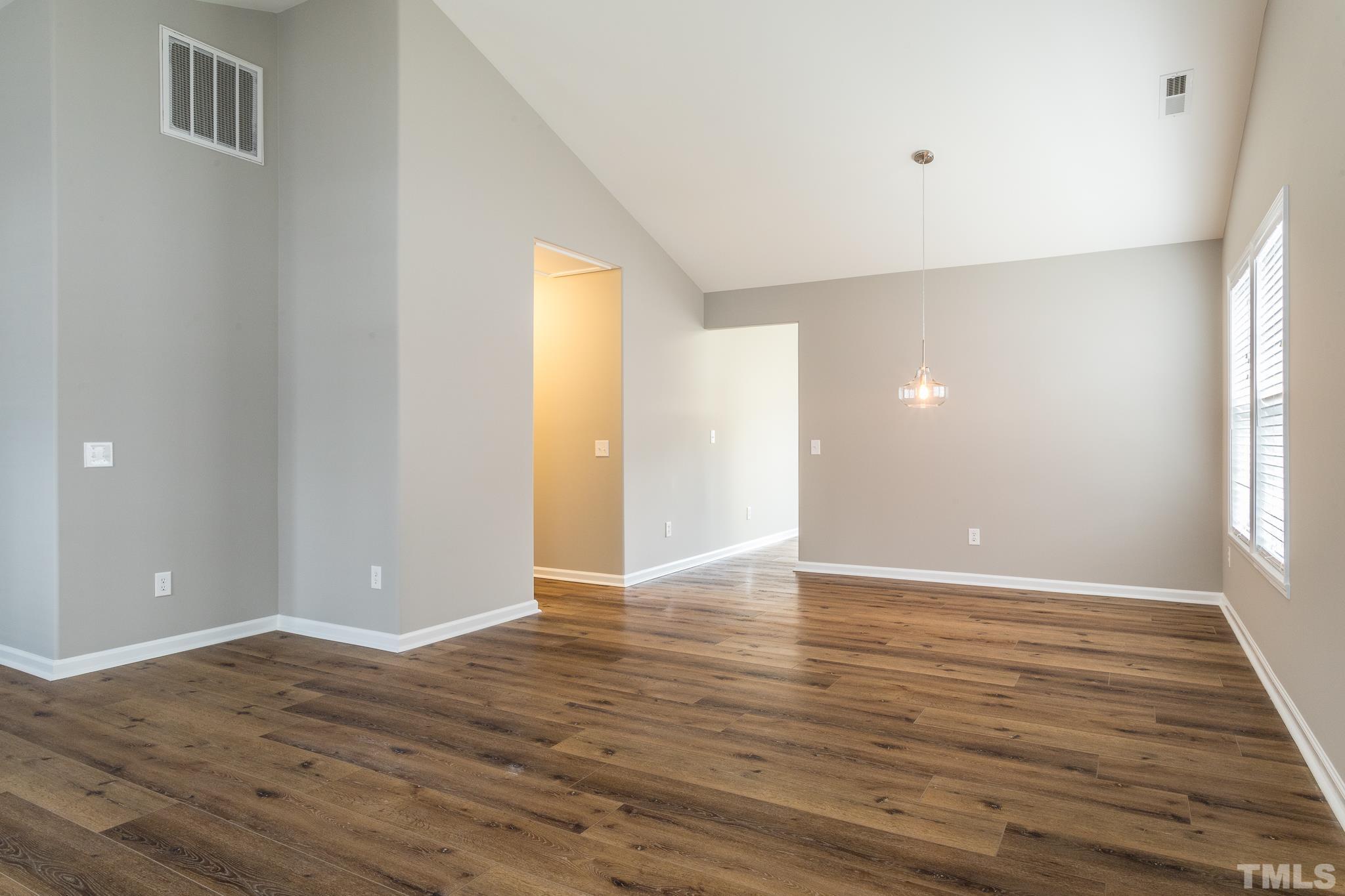 1307 Mallory Lane Durham, NC 27713 - Photo 14 of 29 a view of an empty room with window and wooden floor