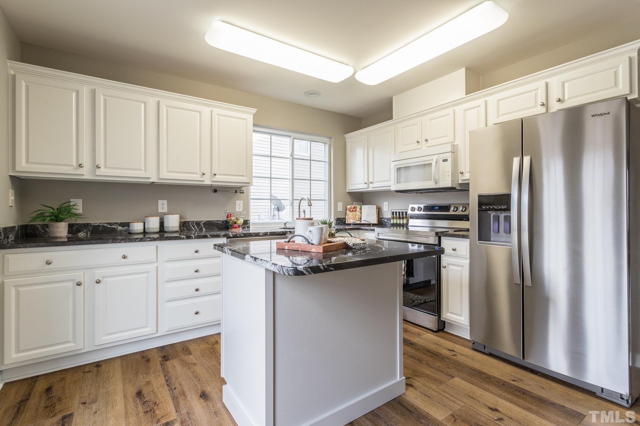 1307 Mallory Lane Durham, NC 27713 - Photo 19 of 29 a kitchen with stainless steel appliances granite countertop a refrigerator sink and cabinets