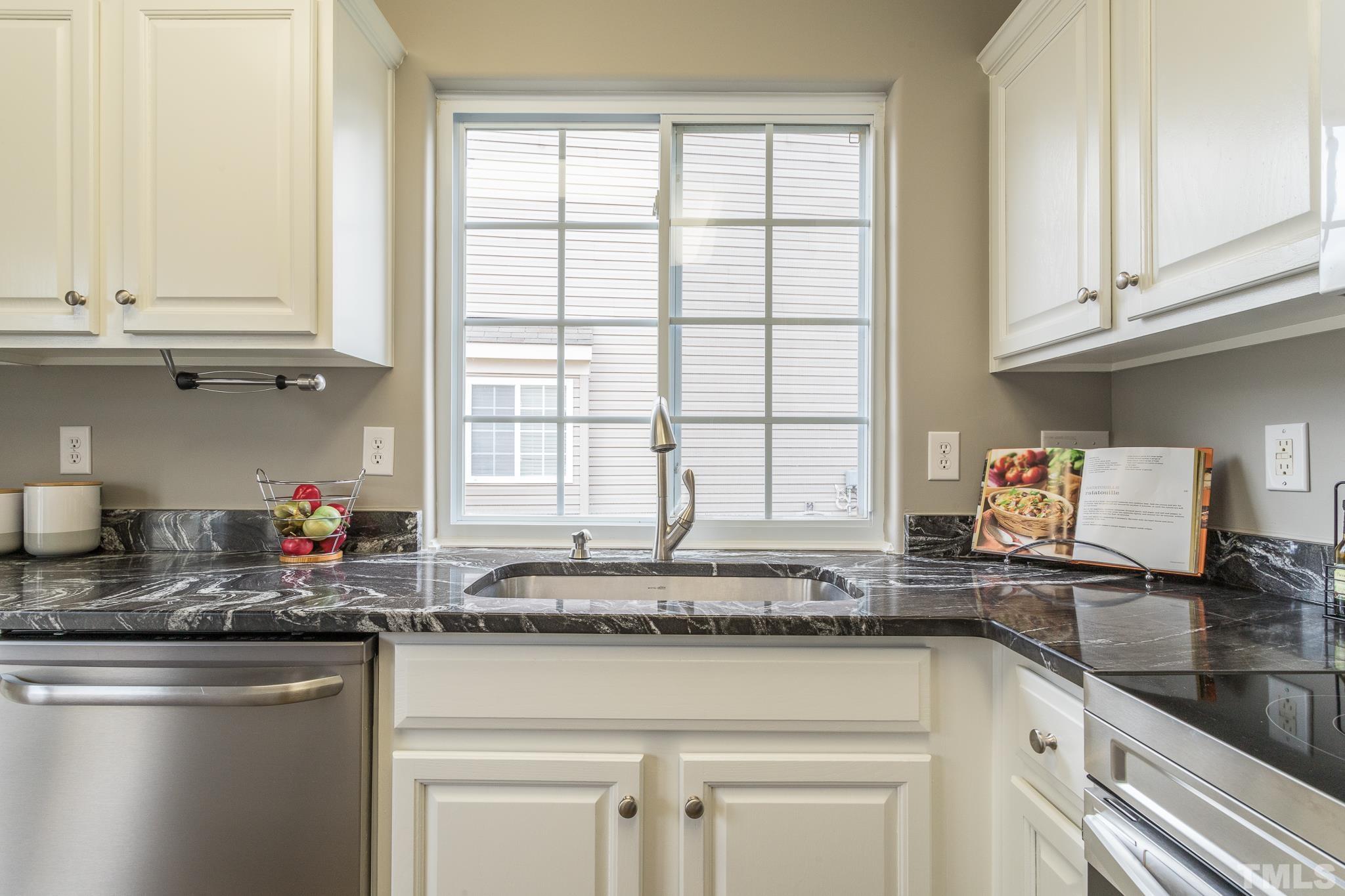 1307 Mallory Lane Durham, NC 27713 - Photo 21 of 29 a kitchen with stainless steel appliances granite countertop a sink stove and cabinets
