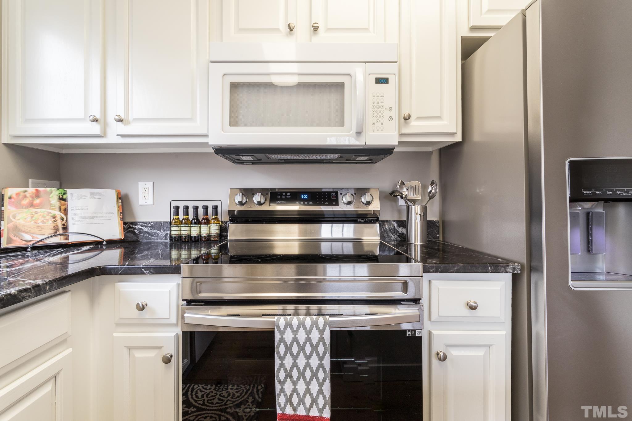 1307 Mallory Lane Durham, NC 27713 - Photo 22 of 29 a stove top oven sitting inside of a kitchen