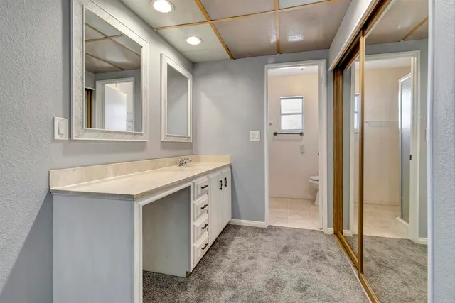a bathroom with a sink a vanity and a mirror