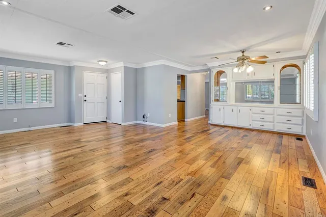 wooden floor in an empty room with a window