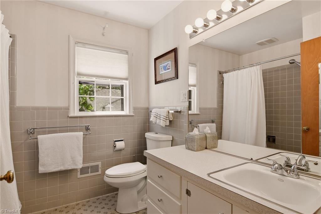 706 Friar Tuck Road Winston-Salem, NC 27104 - Photo 22 of 34 Primary en suite full bath with a vintage vanity