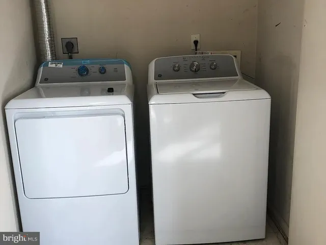 a white toilet sitting next to a bathroom sink and a tub