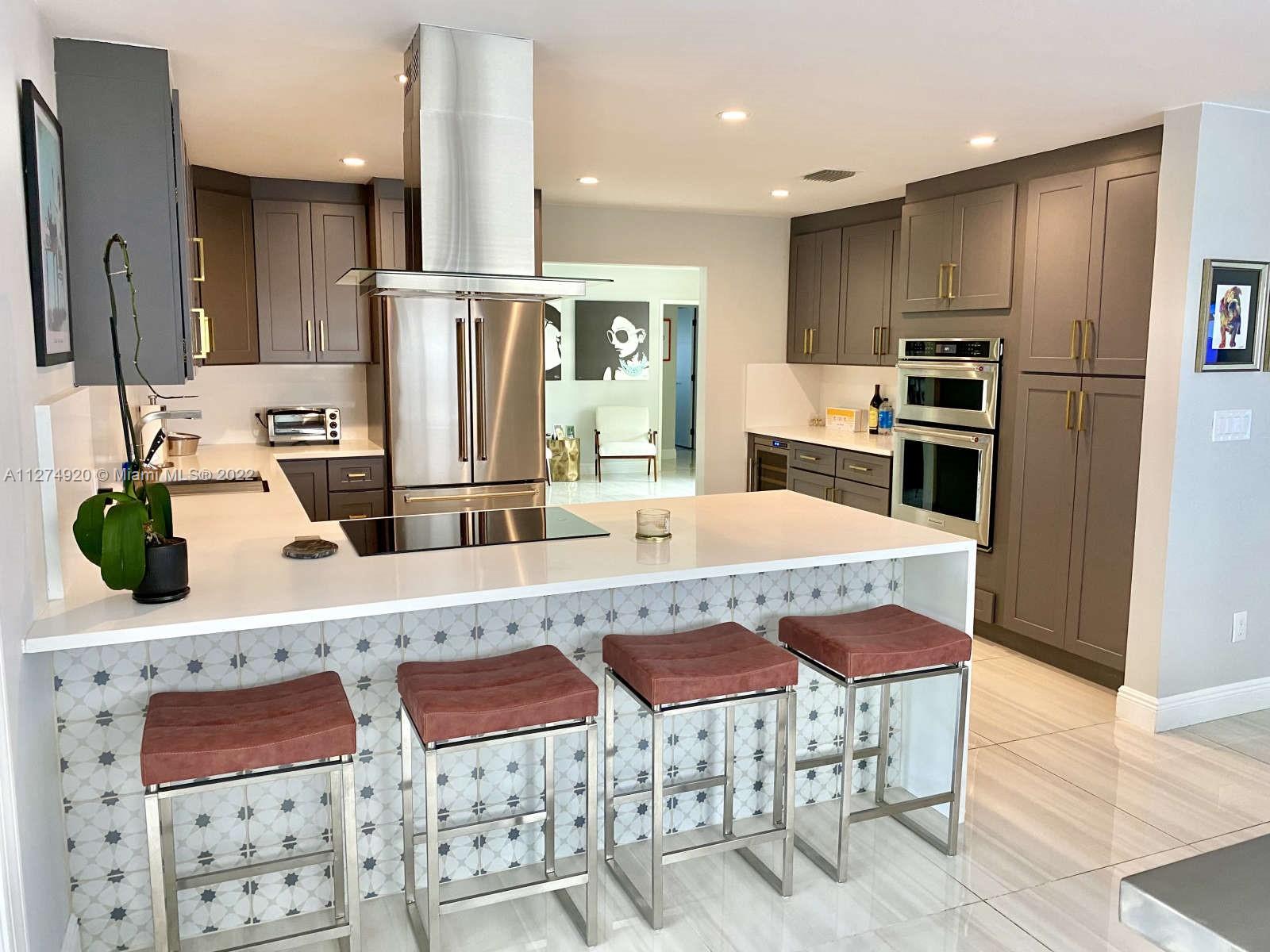 a kitchen with stainless steel appliances granite countertop a sink and refrigerator