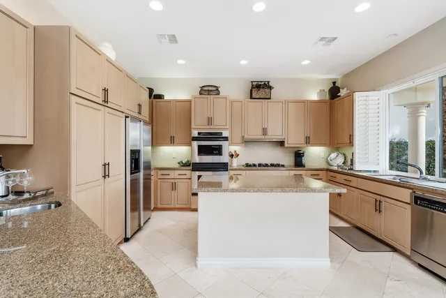 a kitchen with refrigerator and cabinets