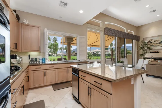 a kitchen with sink stove and cabinets