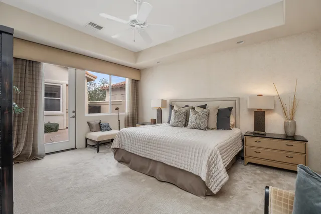 a bedroom with a bed and a large window