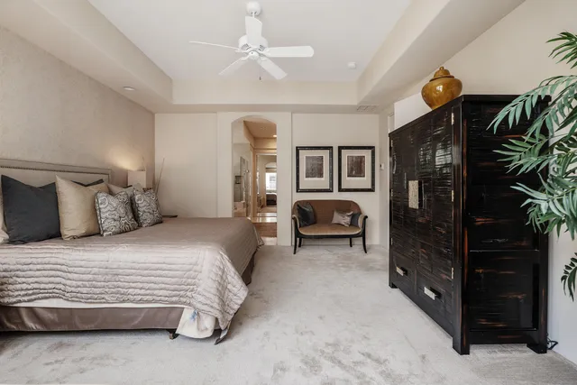 a bedroom with a bed closet and flat tv screen