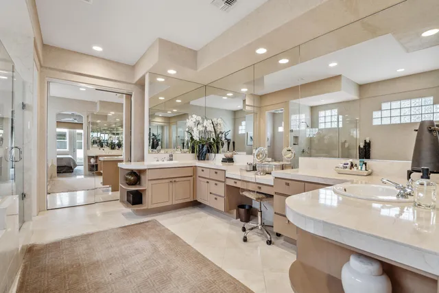 a large white kitchen with a large window and counter space