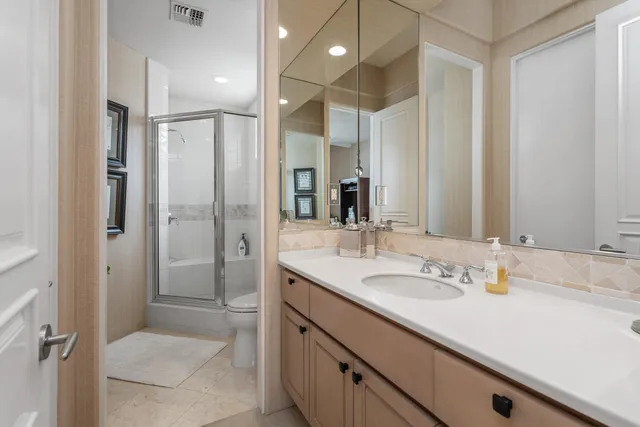 a bathroom with a shower sink double and mirror