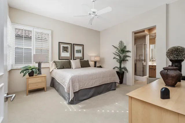 a bedroom with a bed and windows