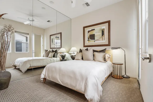 a bedroom with two beds and a couch