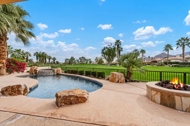 a view of swimming pool with outdoor seating and plants