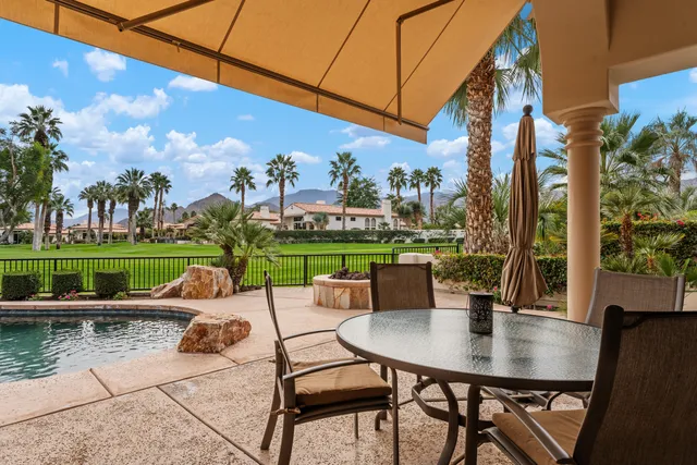 a view of a patio with table and chairs and potted plants