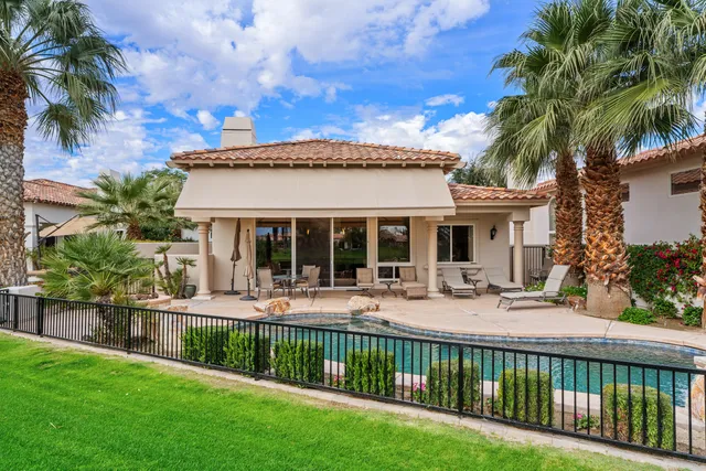a view of a house with a yard and furniture