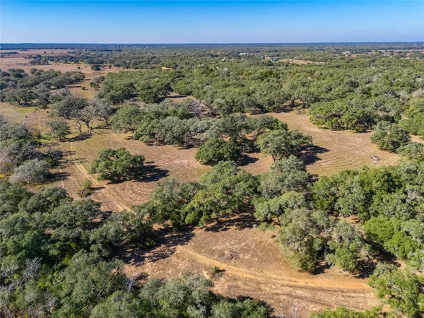 an aerial view of a houses with a yard
