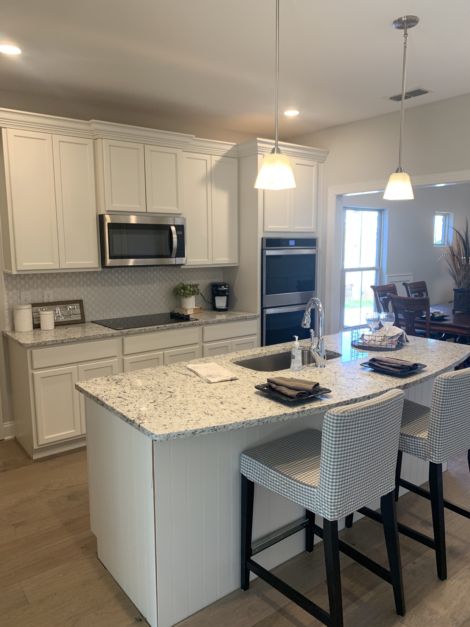 430 Butler Road Mount Juliet, TN 37122 - Photo 6 of 18 a kitchen with stainless steel appliances granite countertop a sink a stove a microwave a center island and cabinets