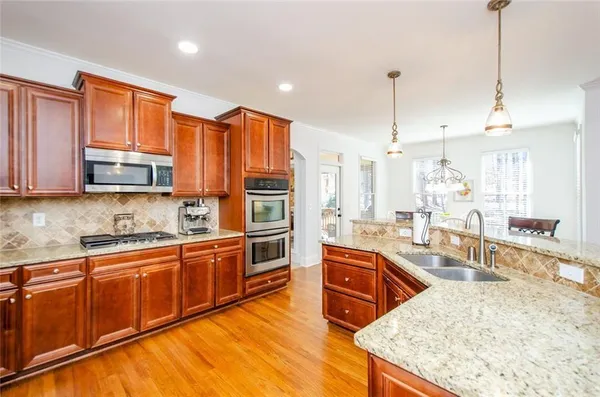 a living room with furniture and a flat screen tv with wooden floor