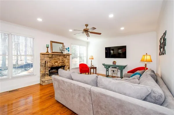 a living room with furniture fireplace and flat screen tv