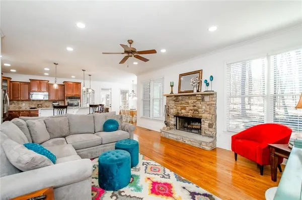 a kitchen with stainless steel appliances granite countertop a sink dishwasher and cabinets with wooden floor