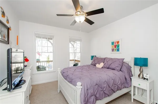 a bed room with a bed and a chair