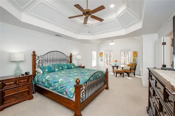 a bedroom with a bed window and a flat screen tv
