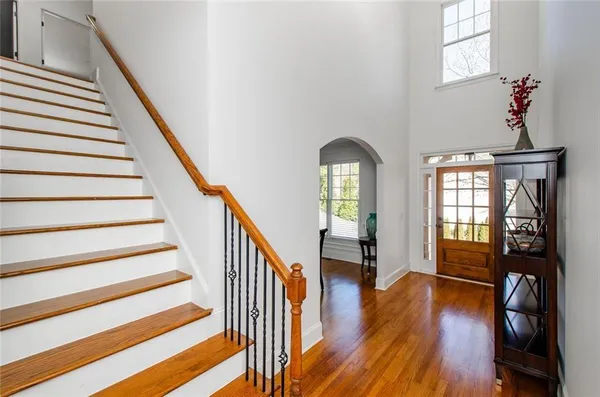 a view of entryway and hall with wooden floor