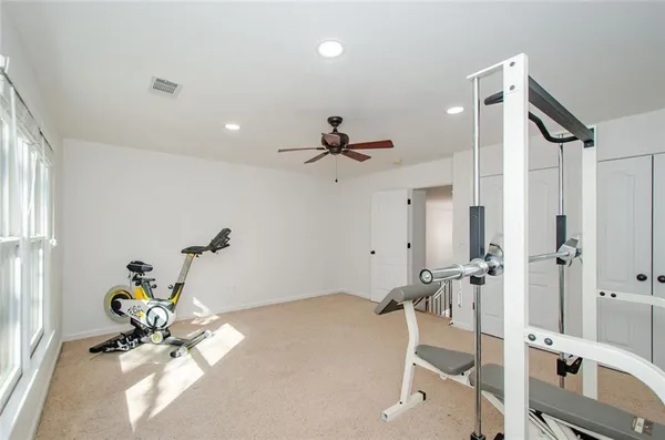 a view of a room with wooden floor and iron stairs