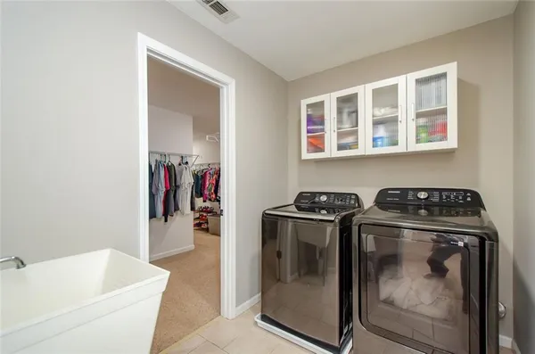 a view of a patio with table and chairs with wooden floor and fence