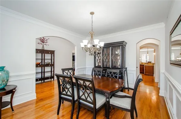 a view of a dining room with furniture wooden floor and chandelier