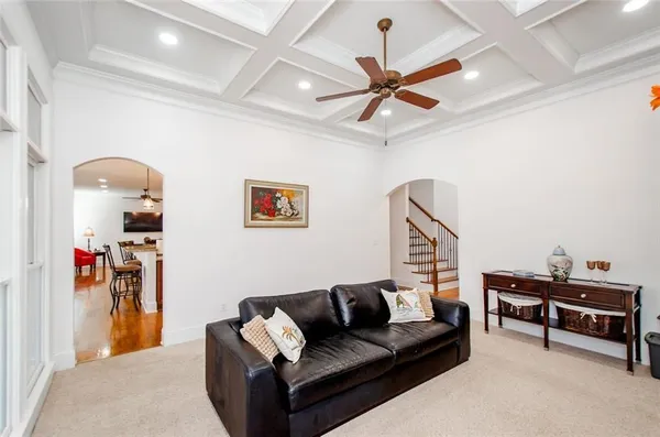 a living room with furniture and a ceiling fan