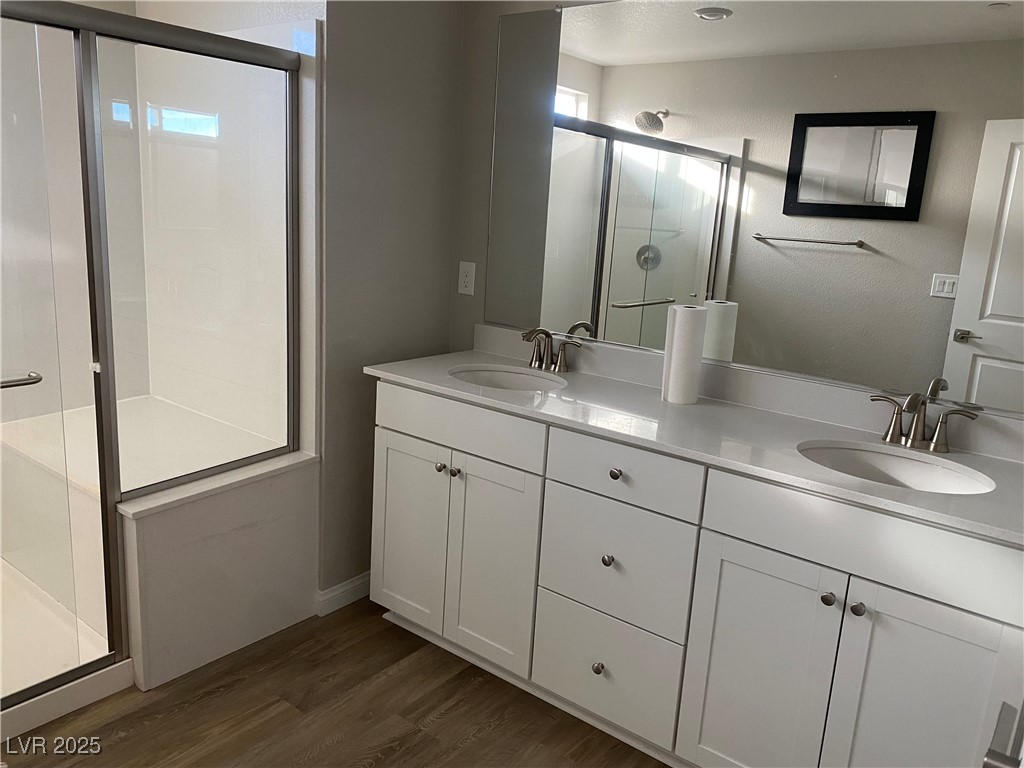 9343 Sully Avenue Las Vegas, NV 89149 - Photo 17 of 27 Bathroom with double vanity, a sink, a stall showe