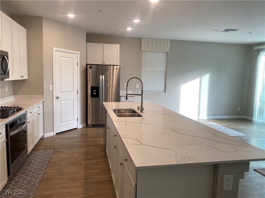 9343 Sully Avenue Las Vegas, NV 89149 - Photo 6 of 27 Kitchen with an island with sink, light stone coun