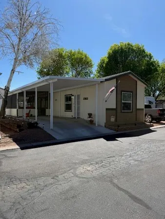a front view of a house with a yard and trees