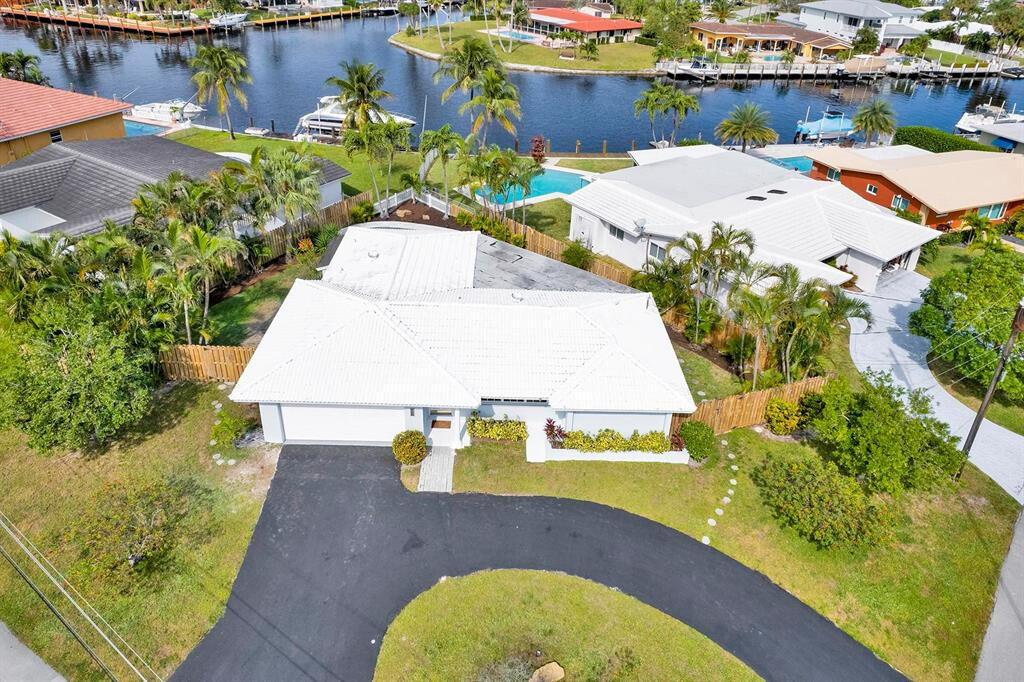 an aerial view of a house with yard swimming pool and outdoor seating
