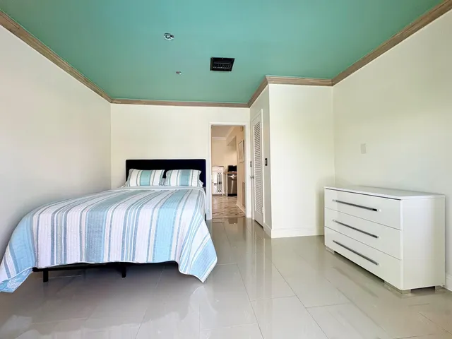 a bedroom with a bed and cabinet