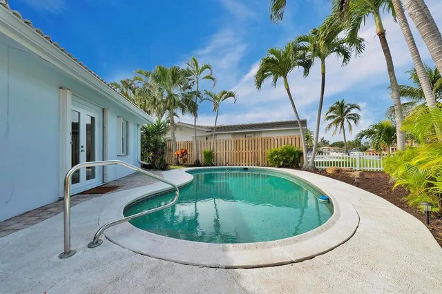 a view of a swimming pool with a yard