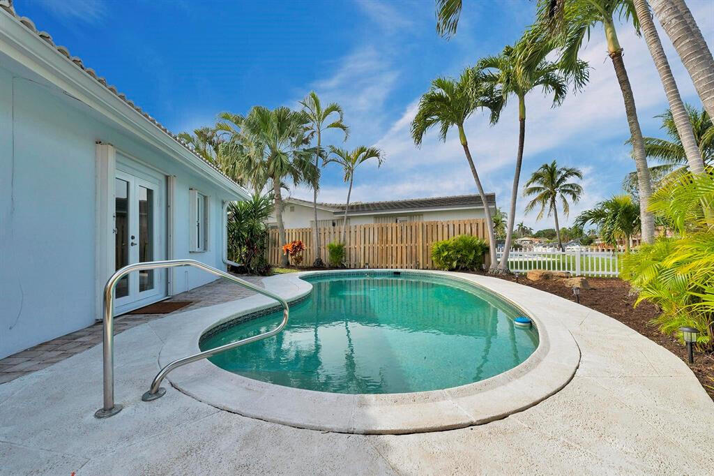 999 Southeast 6th Terrace Pompano Beach, FL 33060 - Photo 18 of 25 a view of a swimming pool with a yard