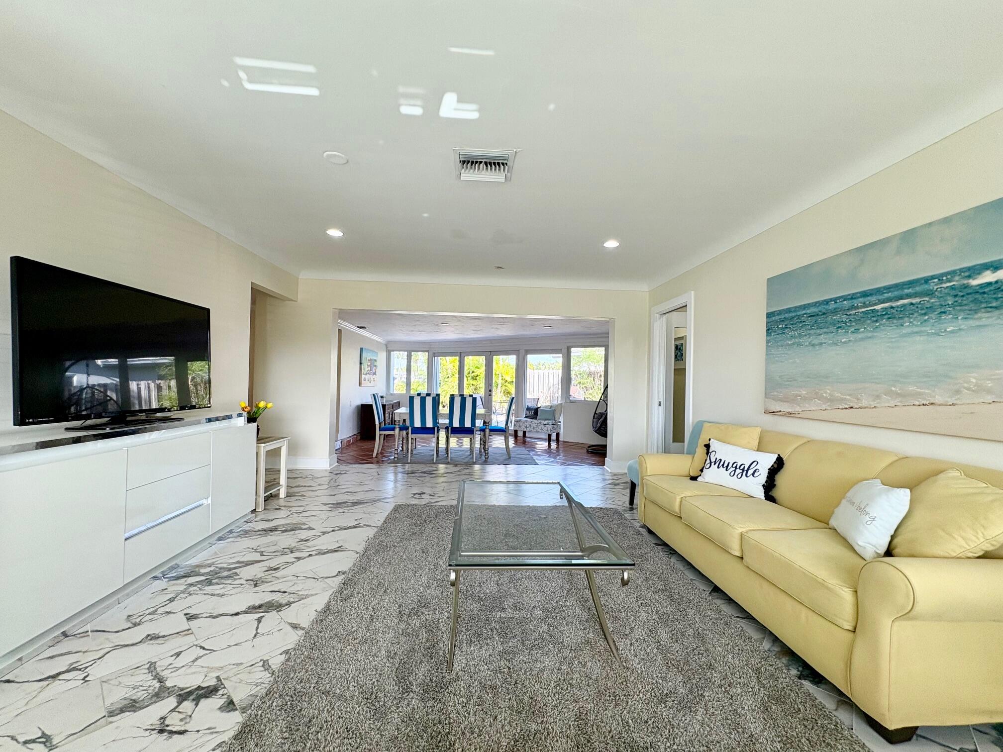 999 Southeast 6th Terrace Pompano Beach, FL 33060 - Photo 6 of 25 a living room with furniture and a flat screen tv